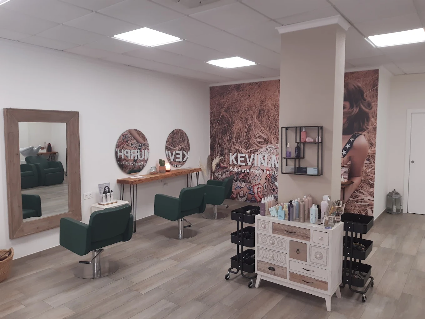 Interior del salón con sillones y productos Kevin Murphy