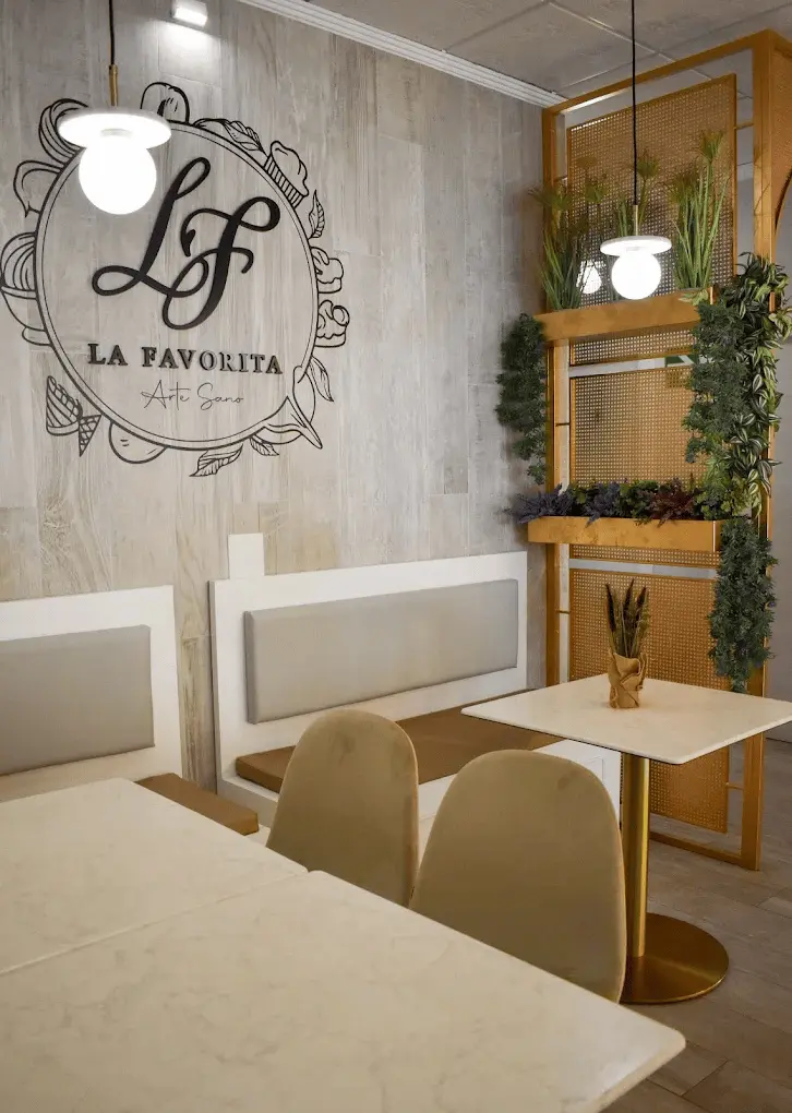 Interior de Cafetería La Favorita con logo Arte Sano en la pared